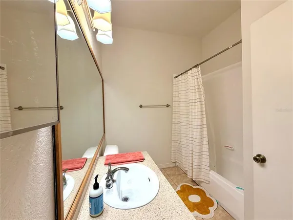 a bathroom with a double vanity sink and mirror