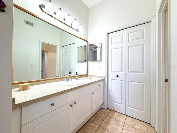 a view of a refrigerator in kitchen and an empty room