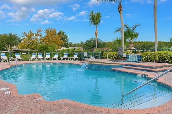 a view of a swimming pool with a table and chairs