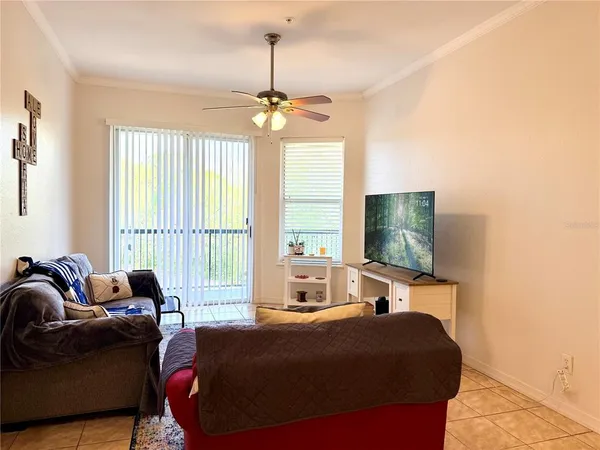 a bedroom with furniture and a flat screen tv