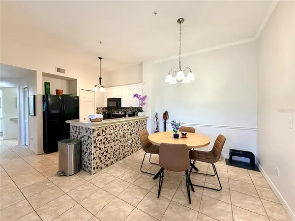 a view of a dining room with furniture a chandelier and wooden floor