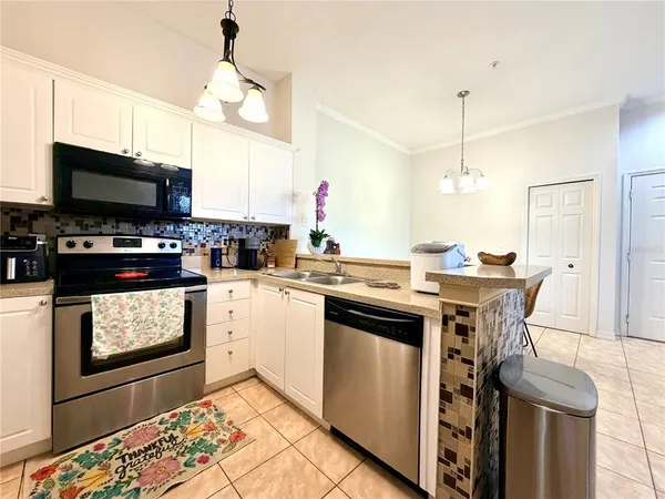 a bed room with a bed and a chandelier