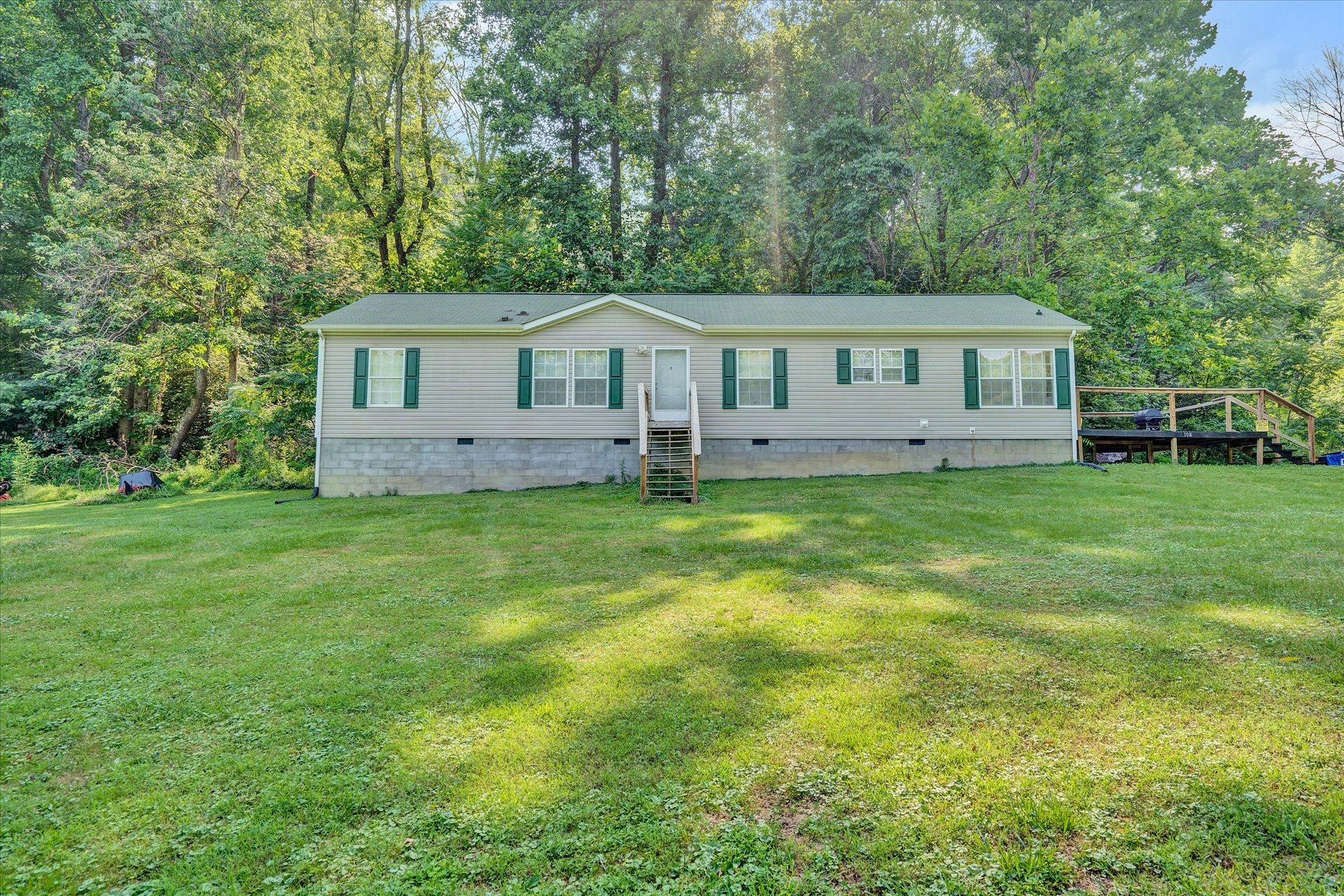 108 Summitt Ridge Drive Blue Ridge, VA 24064 - Photo 1 of 30 a view of a house with a big yard and large trees