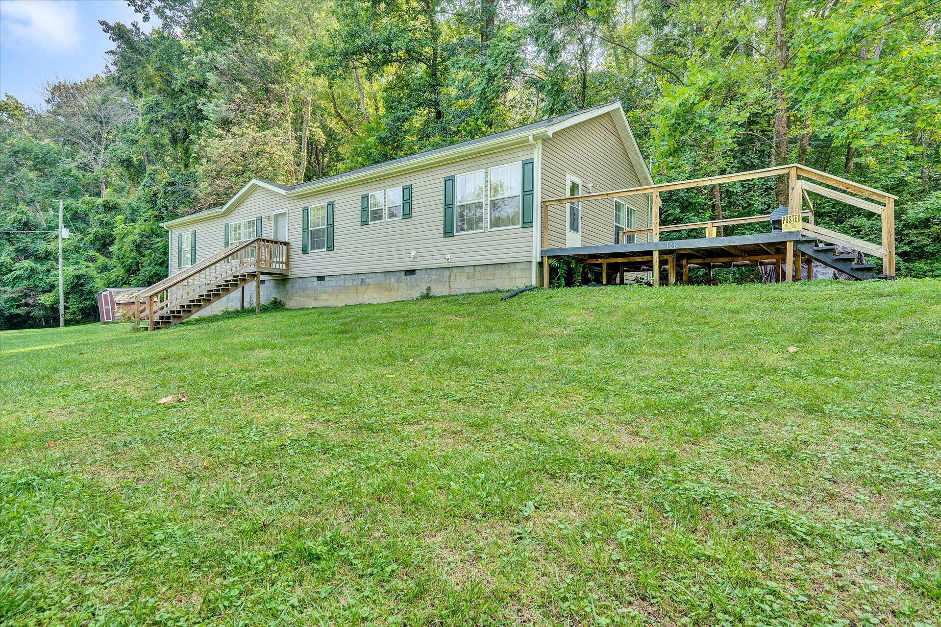 108 Summitt Ridge Drive Blue Ridge, VA 24064 - Photo 4 of 30 a view of a house with backyard and deck