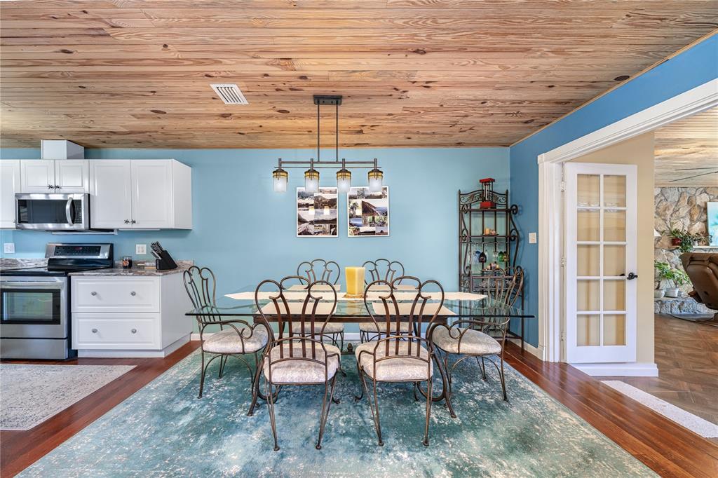 2518 Fort Lane Road Geneva, FL 32732 - Photo 16 of 44 a dining room with furniture and a kitchen view