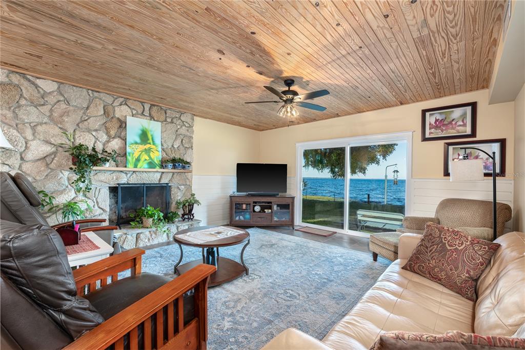 2518 Fort Lane Road Geneva, FL 32732 - Photo 17 of 44 a living room with furniture a fireplace and a large window