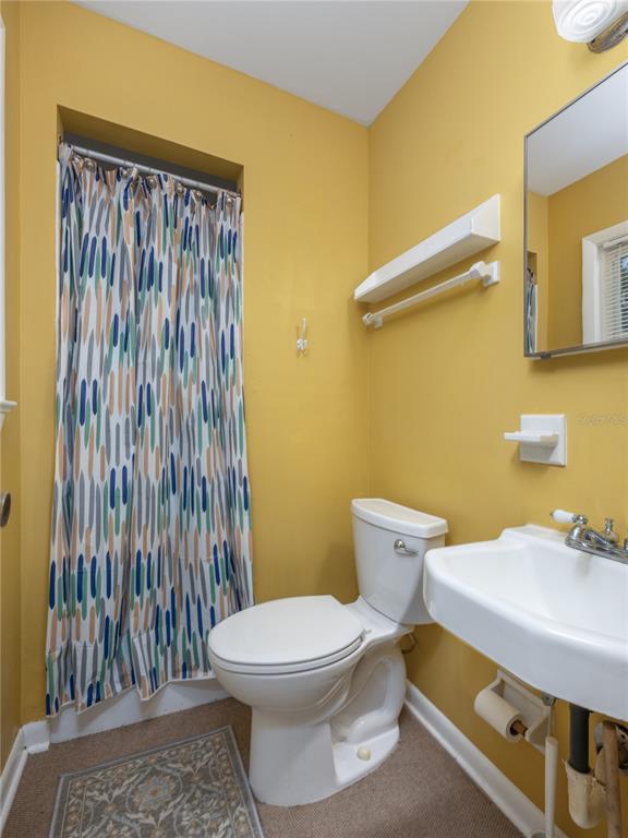 2518 Fort Lane Road Geneva, FL 32732 - Photo 31 of 44 a white toilet sitting next to a bathroom sink