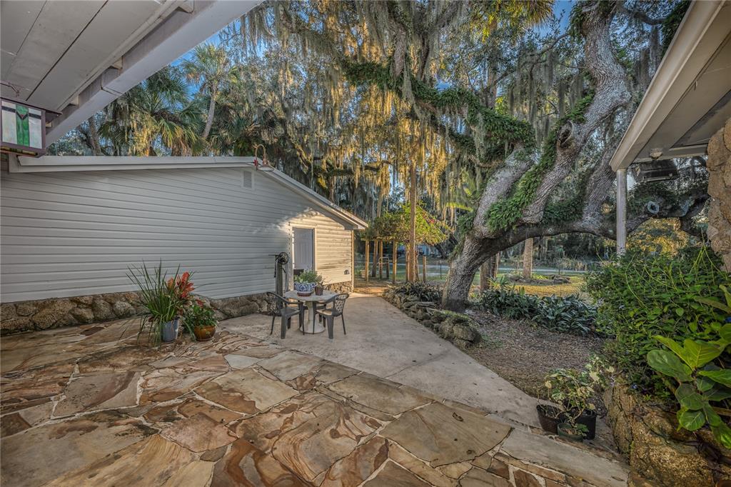 2518 Fort Lane Road Geneva, FL 32732 - Photo 34 of 44 a view of a backyard with table and chairs and potted plants