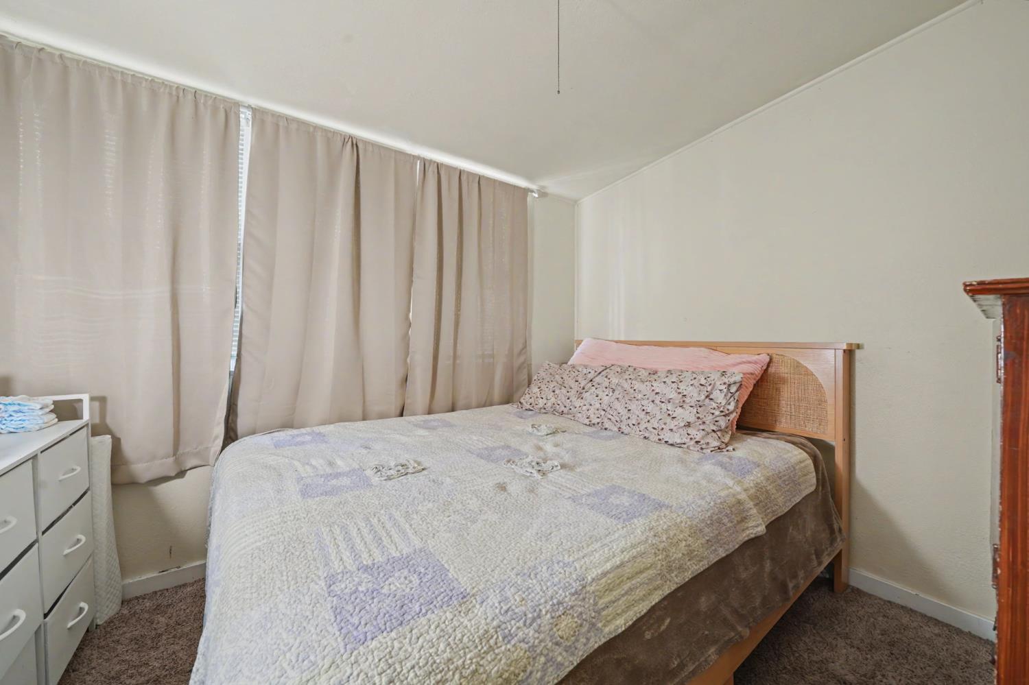411 Rex Avenue Jackson, CA 95642 - Photo 13 of 72 a large bed sitting in a bedroom next to a window
