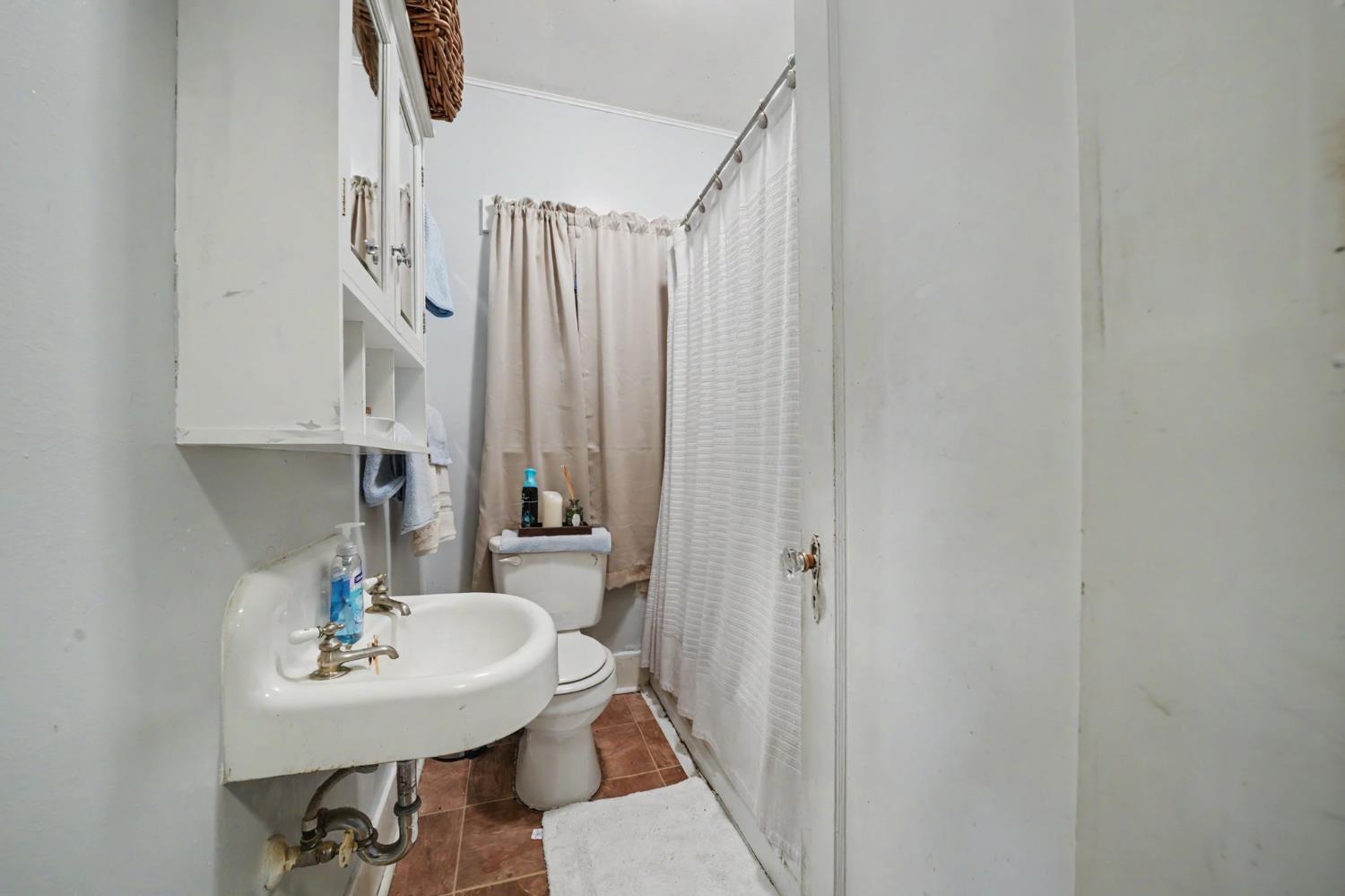 411 Rex Avenue Jackson, CA 95642 - Photo 17 of 72 a bathroom with a sink a mirror and a toilet