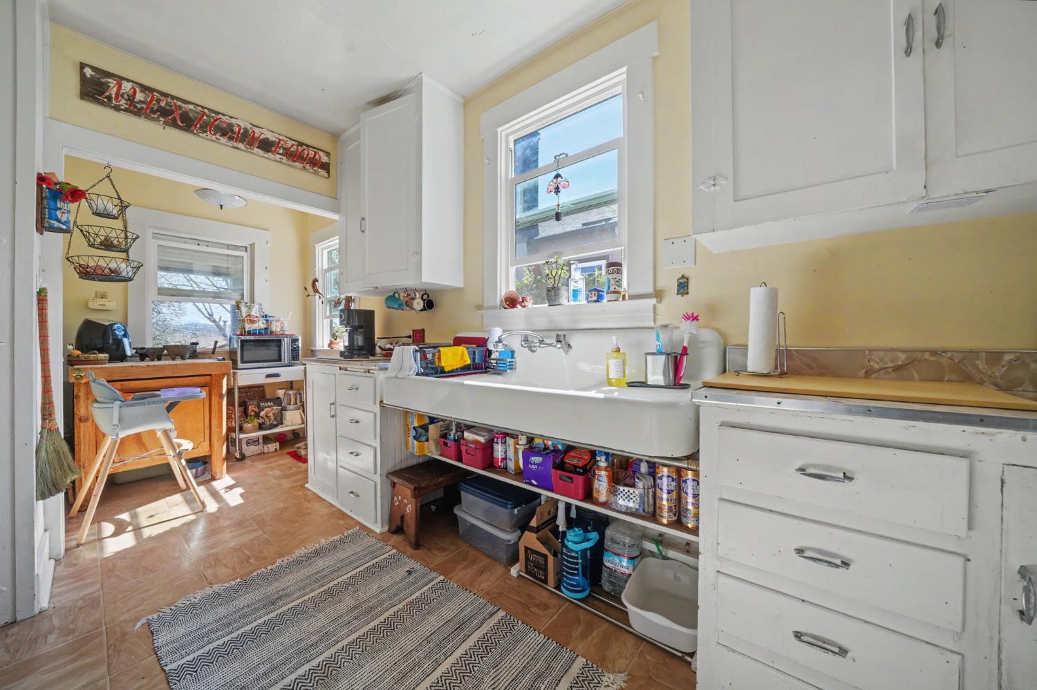 411 Rex Avenue Jackson, CA 95642 - Photo 21 of 72 a open kitchen that has a lot of cabinets a sink and a stove in it