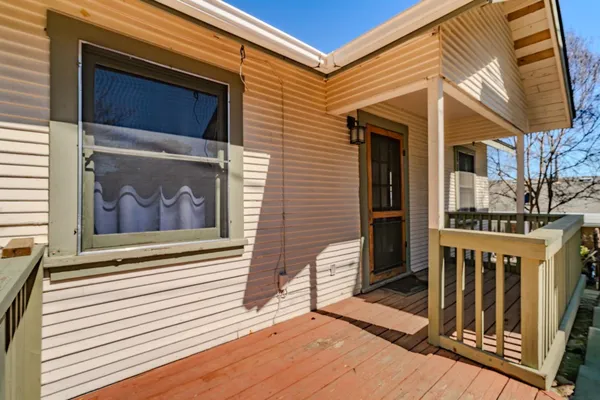 a view of a livingroom with wooden floor and a ceiling fan