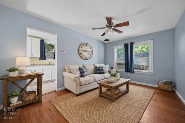 a bathroom with a granite countertop sink and a large mirror next to a window