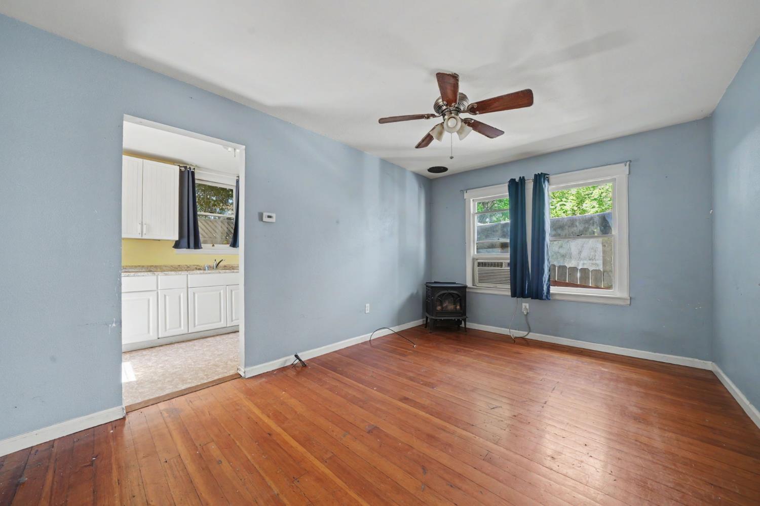 411 Rex Avenue Jackson, CA 95642 - Photo 33 of 72 a view of an empty room with a window and wooden floor