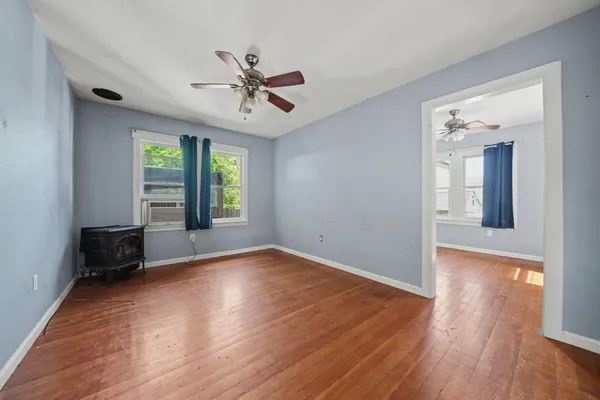 a view of a house with a wooden fence