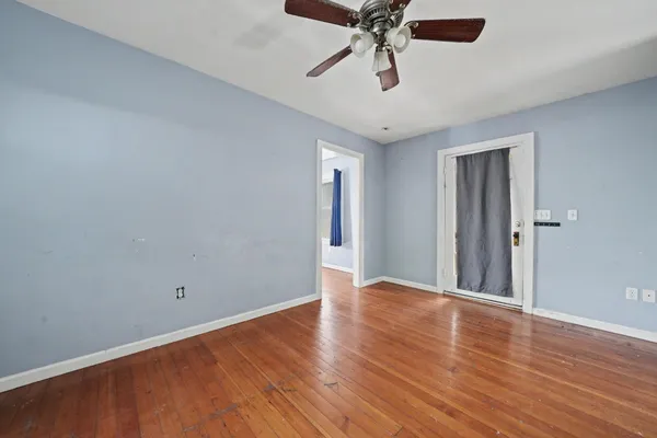 a view of a patio with table and chairs under an umbrella