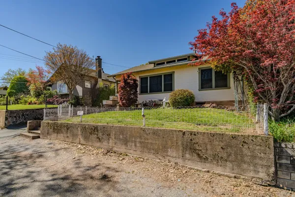 a view of a yard with potted plants