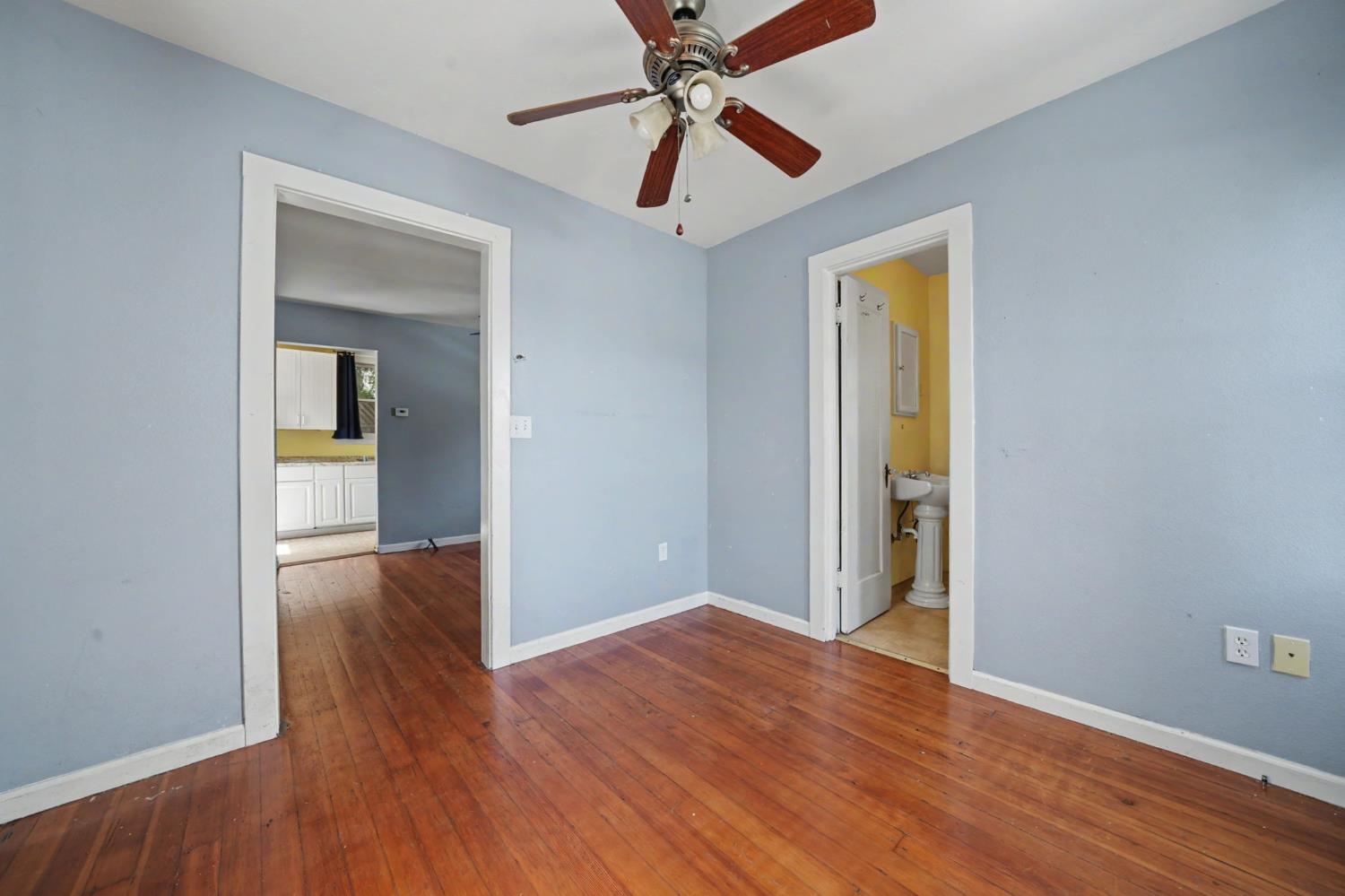 411 Rex Avenue Jackson, CA 95642 - Photo 41 of 72 a view of a livingroom with wooden floor and a ceiling fan