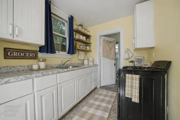 a kitchen with stainless steel appliances a stove sink and cabinets