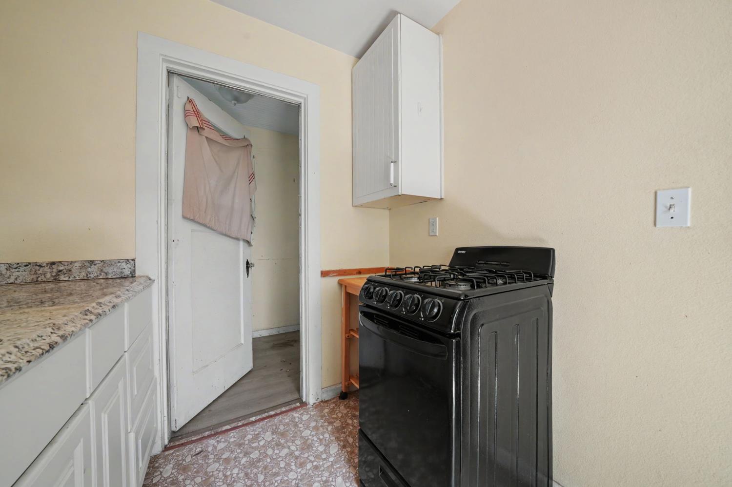411 Rex Avenue Jackson, CA 95642 - Photo 44 of 72 a kitchen with granite countertop a stove and a sink