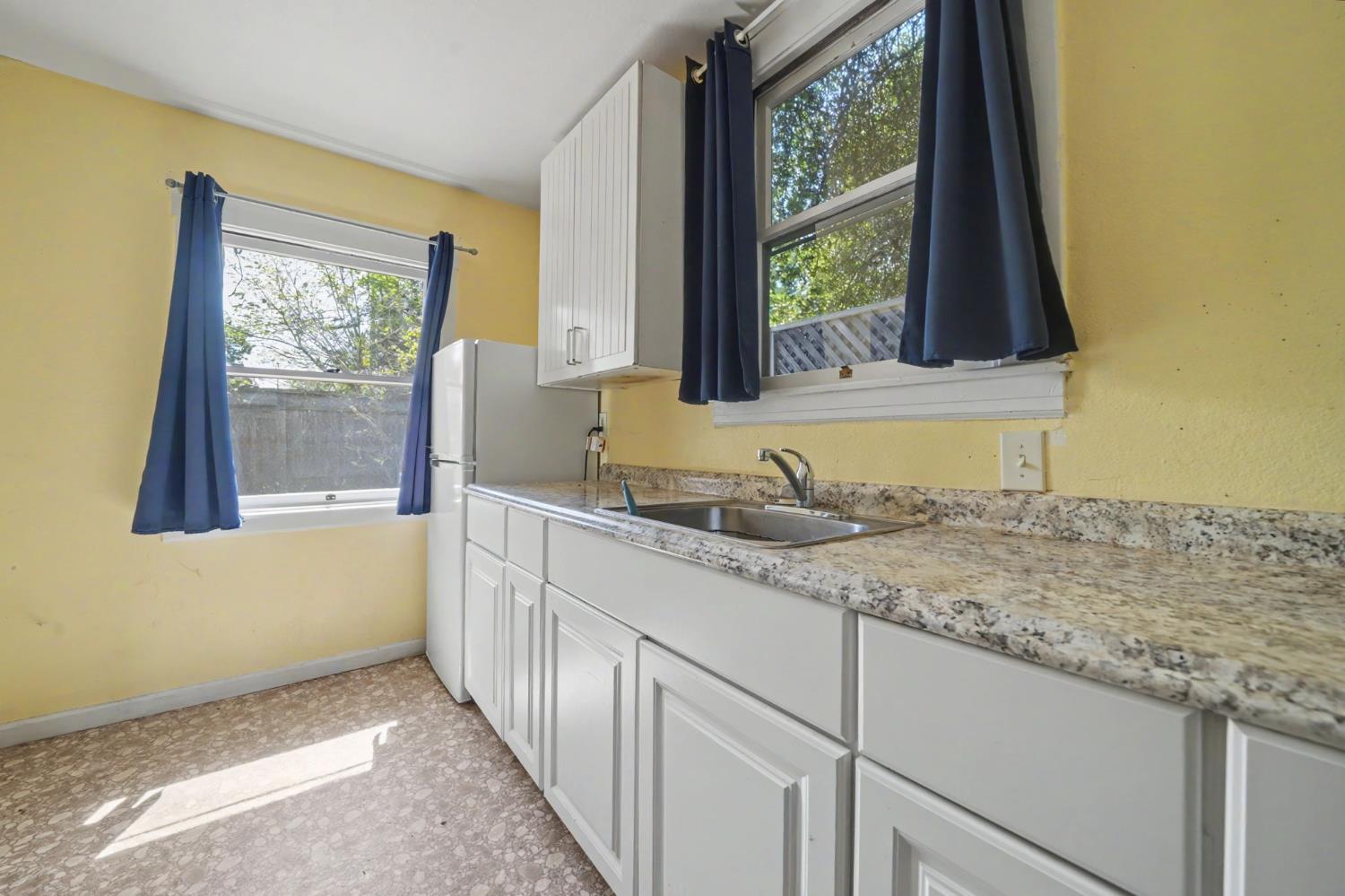 411 Rex Avenue Jackson, CA 95642 - Photo 45 of 72 a bathroom with a granite countertop sink and a large mirror next to a window