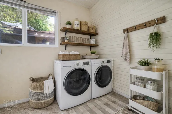 a view of a patio with table and chairs with wooden fence and plants