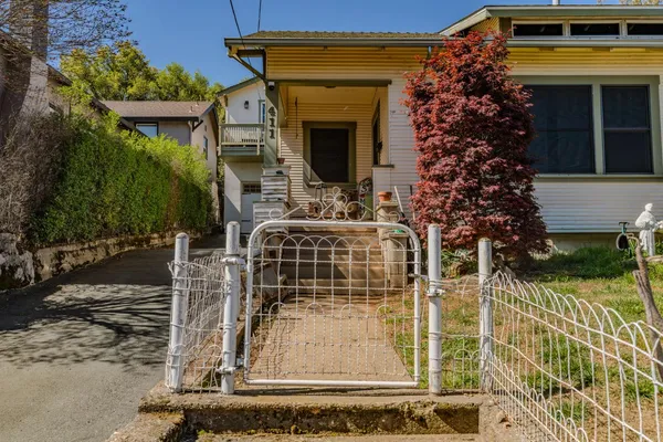 a living room with furniture a large window and a chandelier