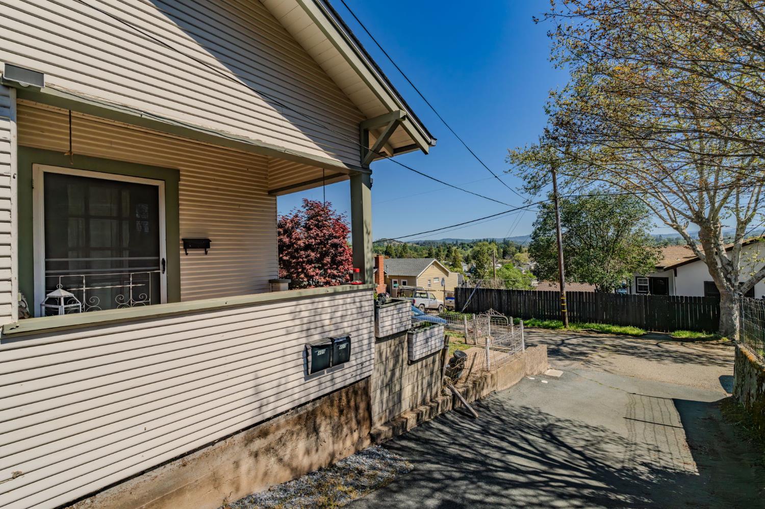 411 Rex Avenue Jackson, CA 95642 - Photo 66 of 72 a view of a patio with table and chairs with wooden fence and plants