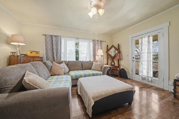 a large bed sitting in a bedroom next to a window
