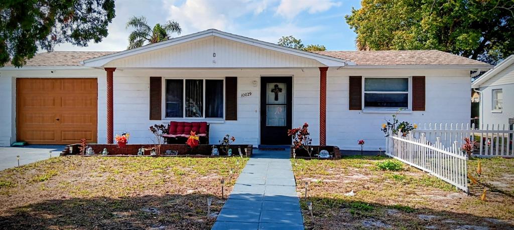 10029 Brandywine Lane Port Richey, FL 34668 - Photo 1 of 11 a front view of a house with a yard
