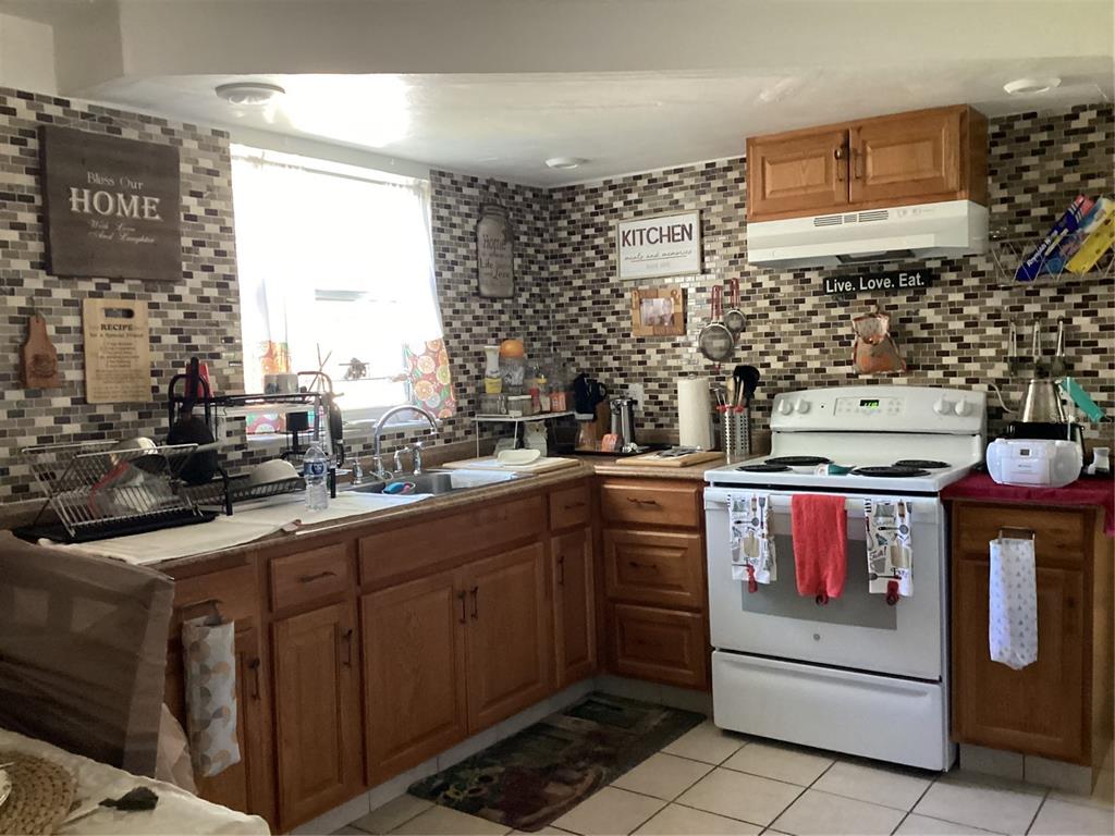 10029 Brandywine Lane Port Richey, FL 34668 - Photo 2 of 11 a kitchen with stainless steel appliances a stove and a sink