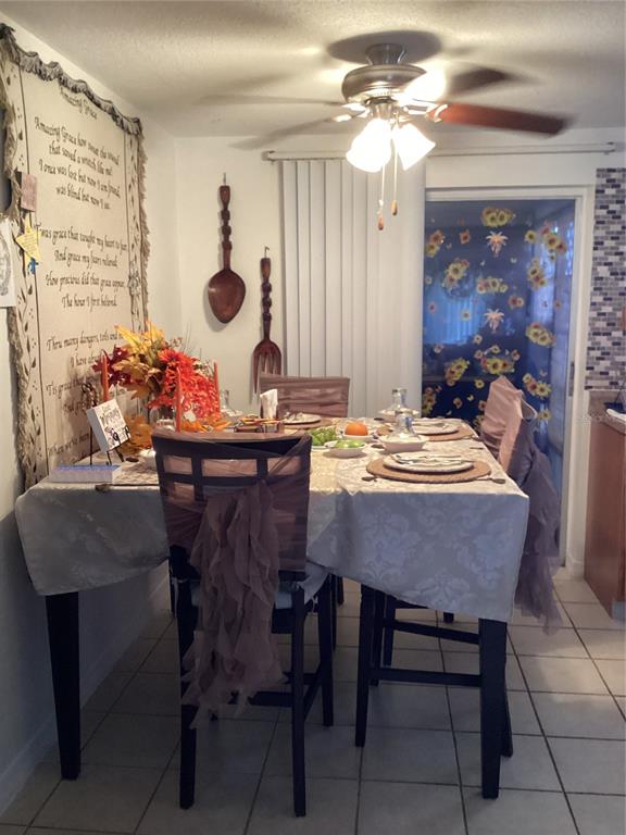 10029 Brandywine Lane Port Richey, FL 34668 - Photo 3 of 11 a view of a dining room with furniture and chandelier