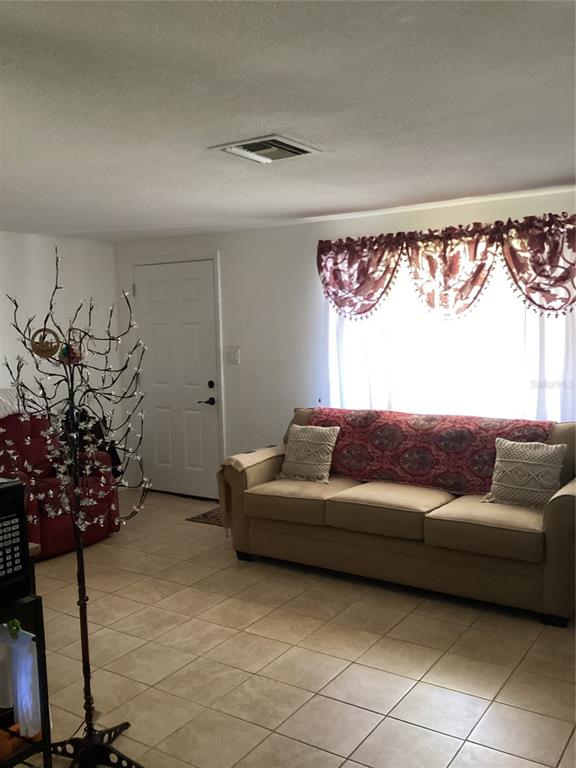 10029 Brandywine Lane Port Richey, FL 34668 - Photo 6 of 11 a living room with furniture and flowers