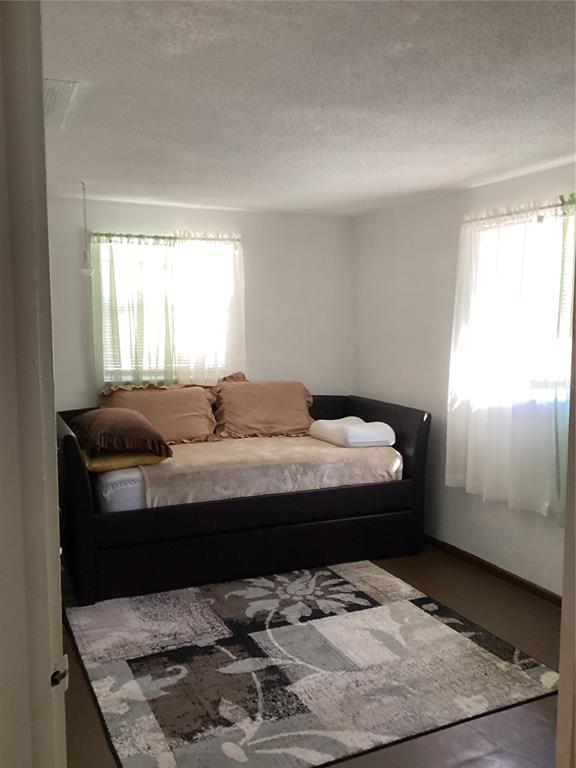 10029 Brandywine Lane Port Richey, FL 34668 - Photo 7 of 11 a bed sitting in a bedroom next to a window