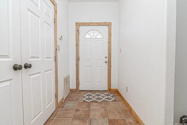 a view of a hallway with front door