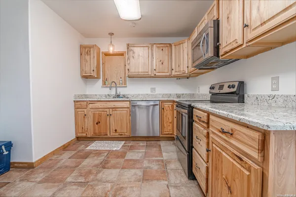 a kitchen with stainless steel appliances granite countertop a sink and cabinets