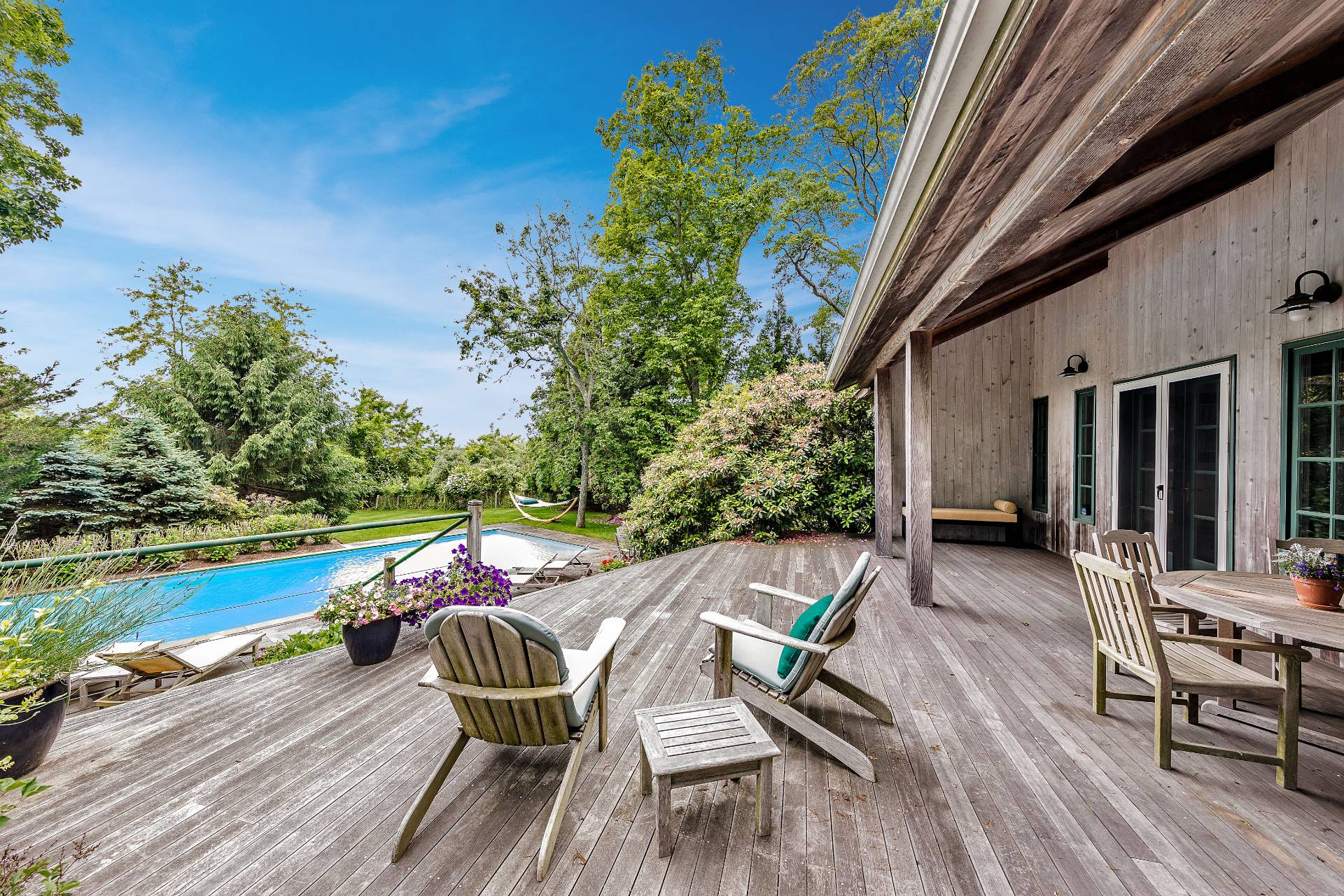 22 Casey Lane Bridgehampton, NY 11932 - Photo 16 of 24 a view of a patio with lawn chairs and wooden floor