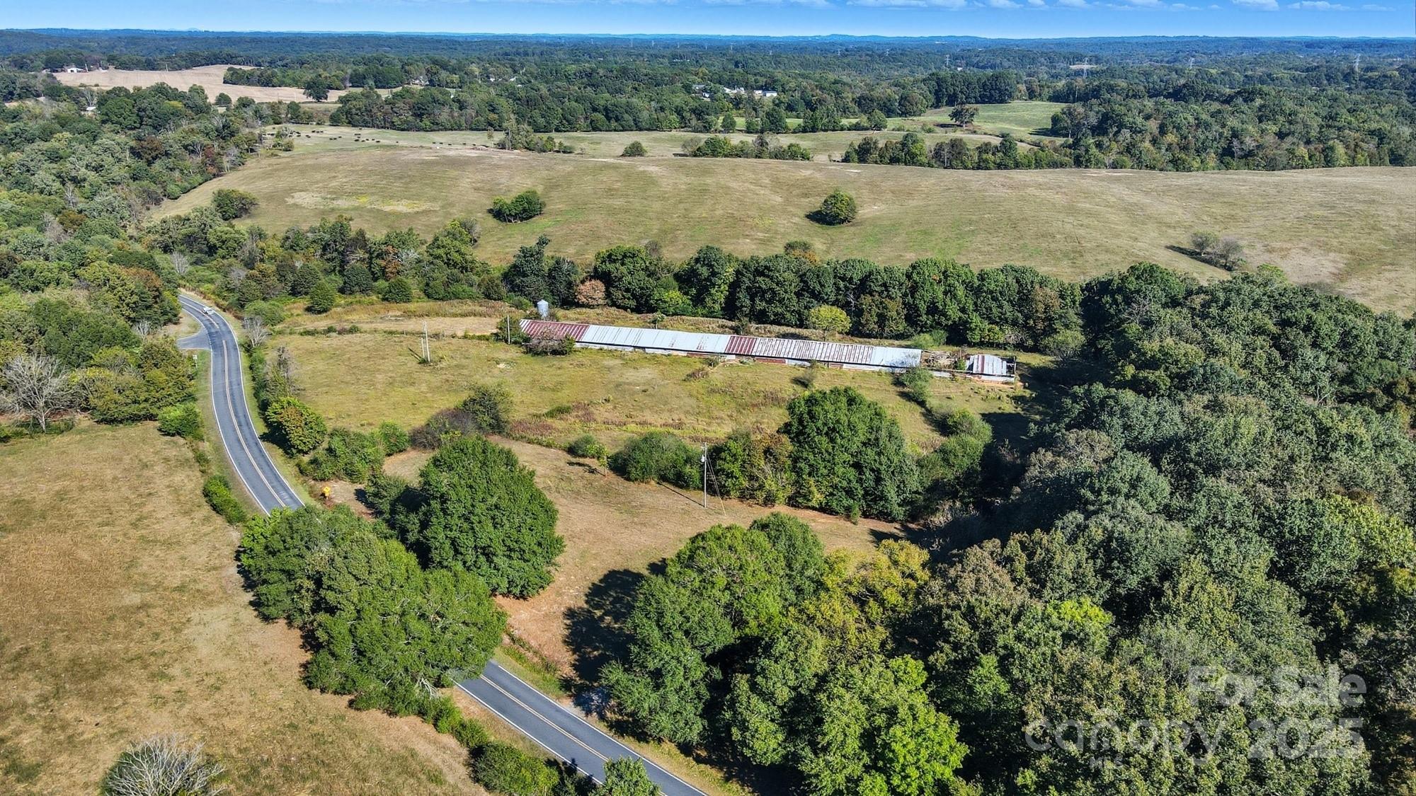 2686 Love Mill Road Stanfield, NC 28163 - Photo 2 of 3 an aerial view of residential houses with outdoor space and river