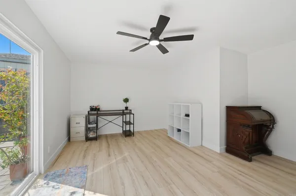 a view of a workspace with furniture and a window