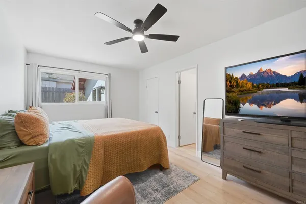 a bedroom with a bed and a flat screen tv