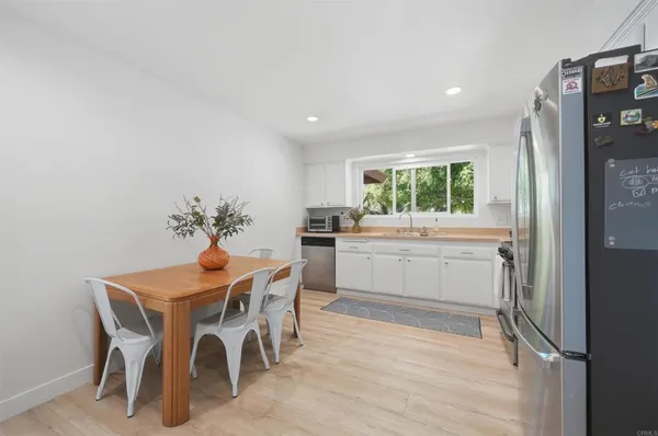 a kitchen with a table and chairs in it