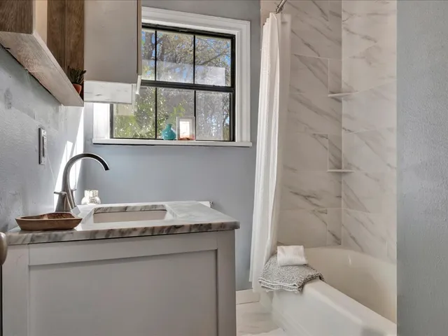 a view of empty room with wooden floor and entryway