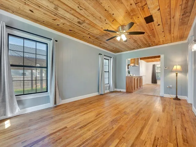 a view of empty room with wooden floor