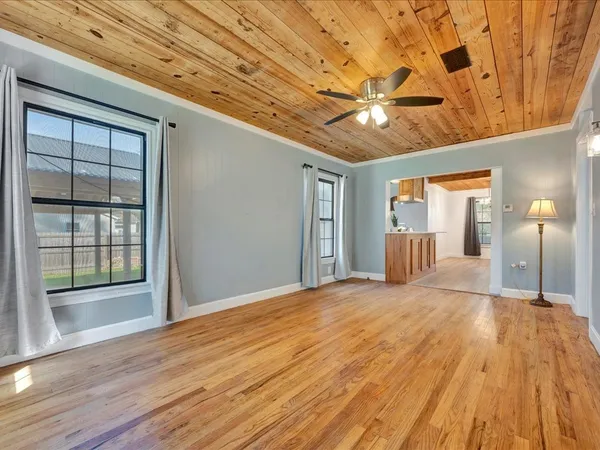 a view of empty room with wooden floor