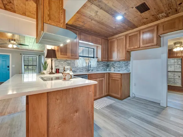 a kitchen with stainless steel appliances granite countertop a sink stove and cabinets