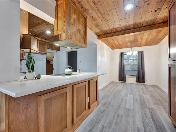 a kitchen with stainless steel appliances granite countertop a sink and wooden floors