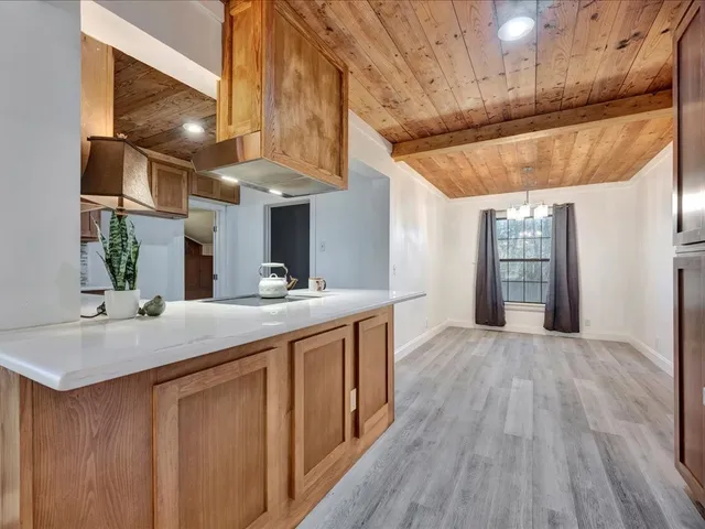 a kitchen with stainless steel appliances granite countertop a sink and wooden floors