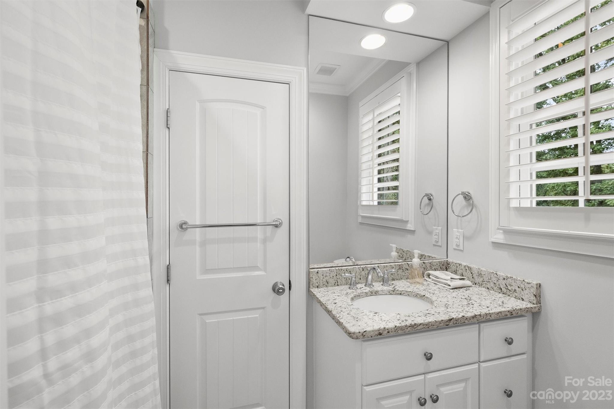 3118 Sharon View Road Charlotte, NC 28210 - Photo 15 of 48 a bathroom with a granite countertop sink and a mirror