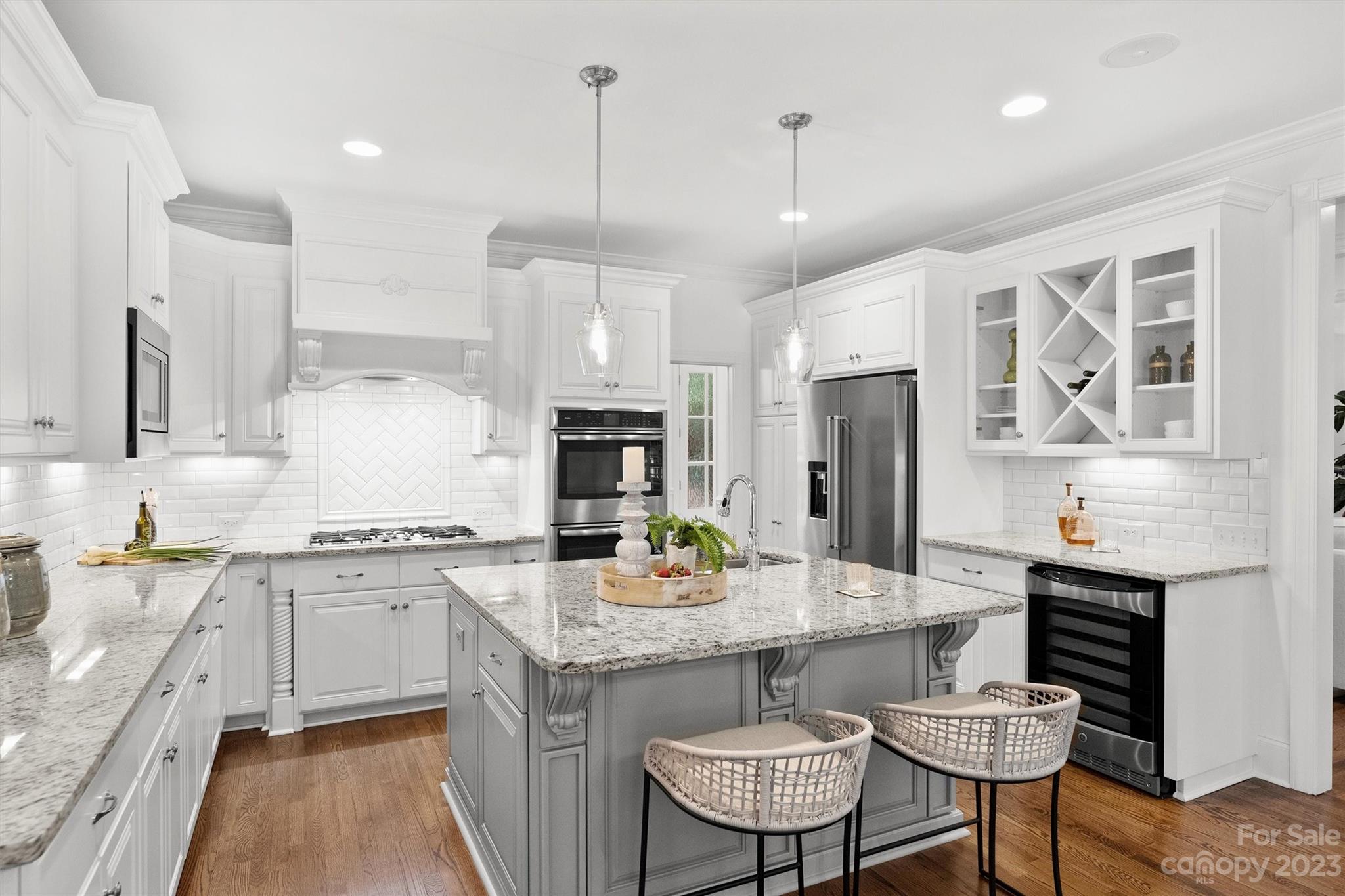 3118 Sharon View Road Charlotte, NC 28210 - Photo 3 of 48 a kitchen with granite countertop kitchen island stainless steel appliances a sink a stove a table and chairs