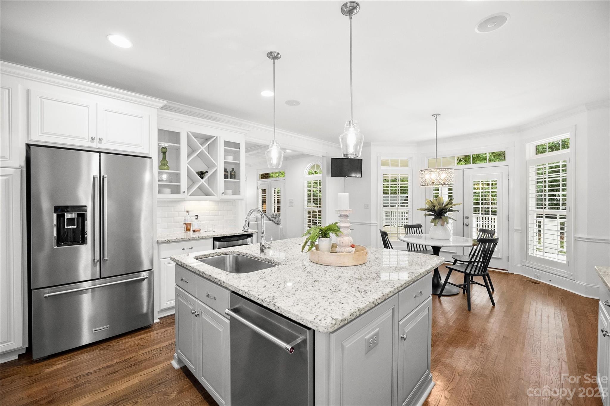 3118 Sharon View Road Charlotte, NC 28210 - Photo 38 of 48 a kitchen with stainless steel appliances granite countertop a kitchen island a refrigerator a table and chairs